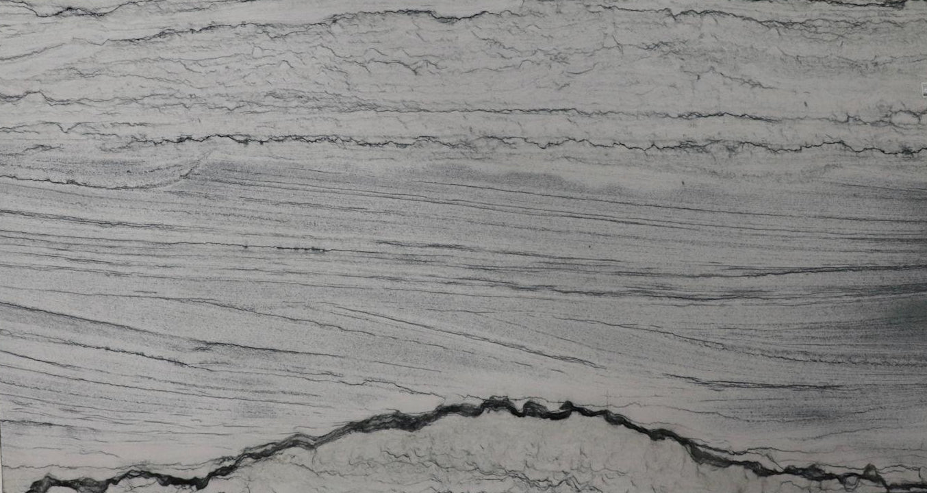 Large slab of gray marble with visible veins on display